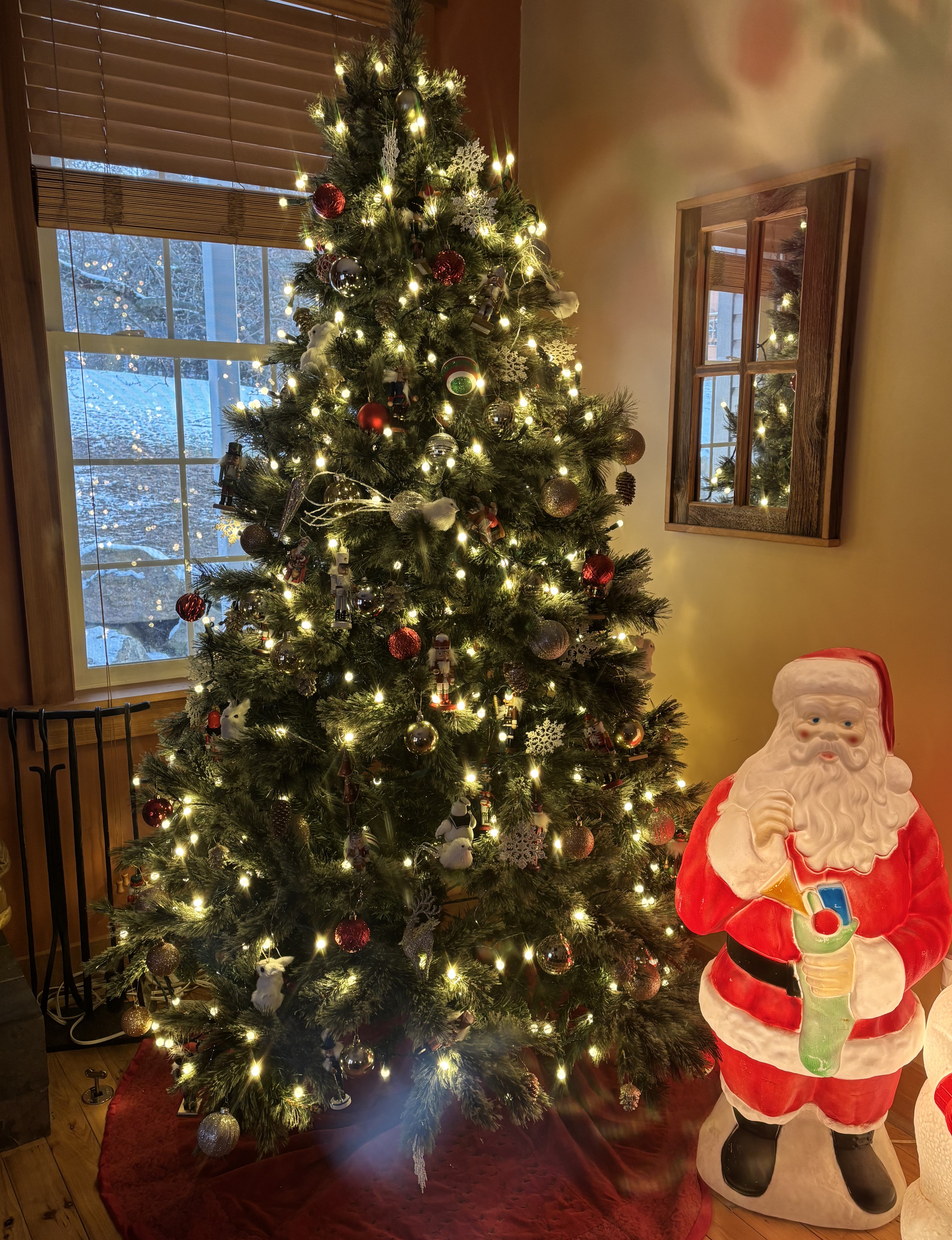 Christmas Tree Lit in Front of Window with Santa to Left