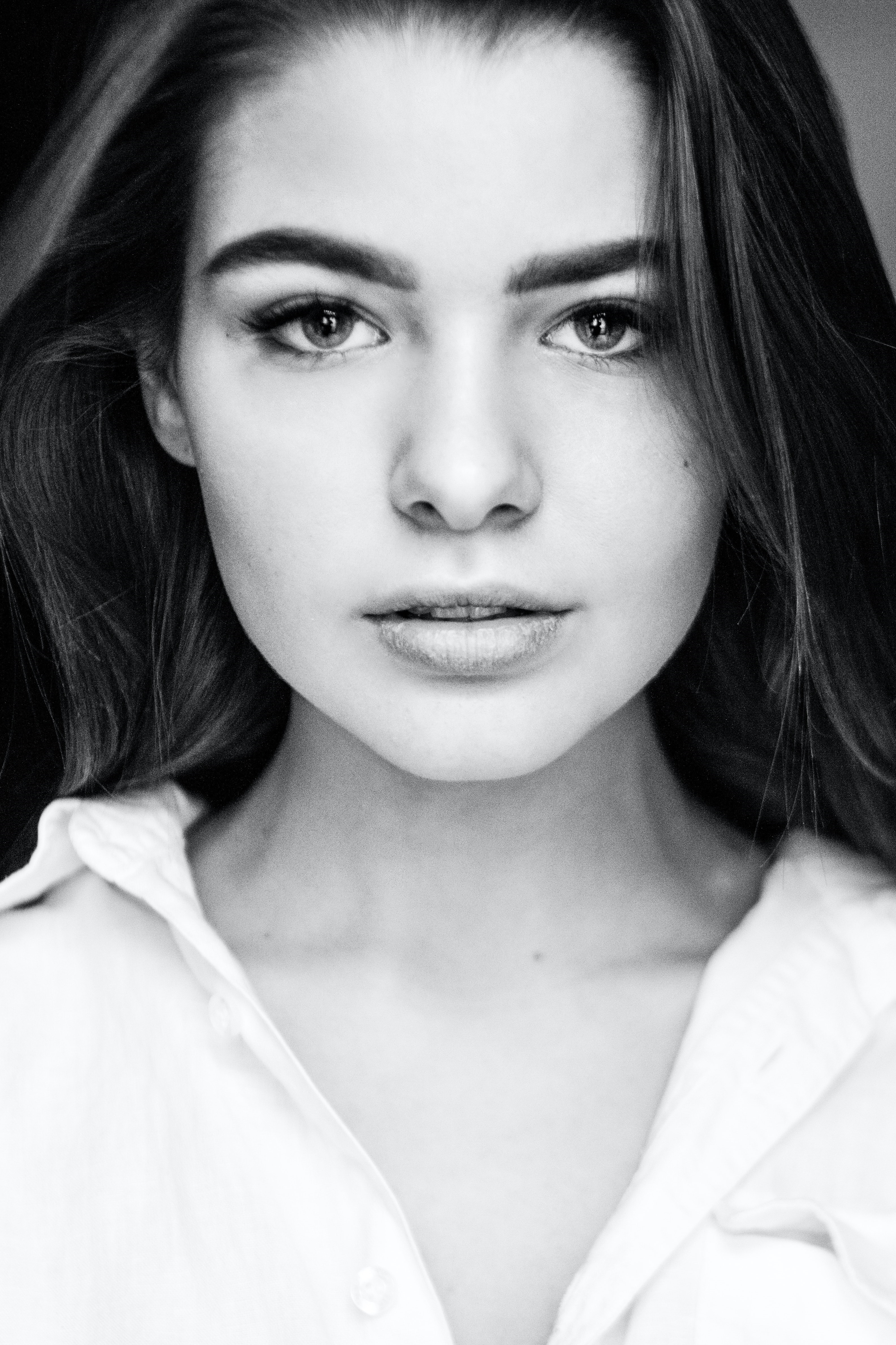 Dark Haired Woman in White Shirt with Clear Skin